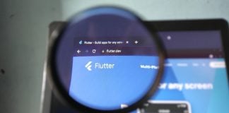 Will FanDuel Predicts catch up to prediction markets rivals? The Flutter logo through a magnifying glass