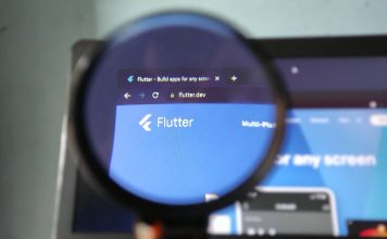 Will FanDuel Predicts catch up to prediction markets rivals? The Flutter logo through a magnifying glass