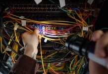 Man working with wires and flash light