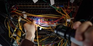 Man working with wires and flash light