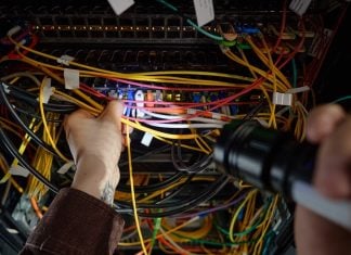 Man working with wires and flash light