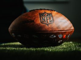 NFL football on grass in dark light
