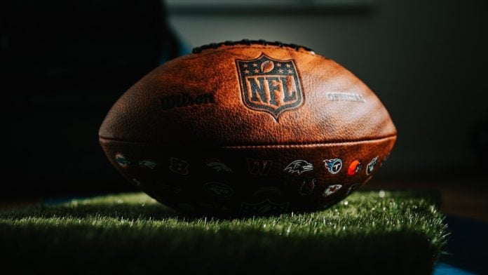 NFL football NFL football on grass in dark light