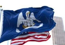 The state flag of Louisiana and the U.S. flag