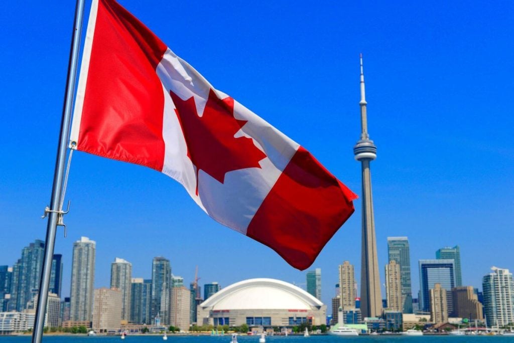 The flag of Canada with Toronto in the background